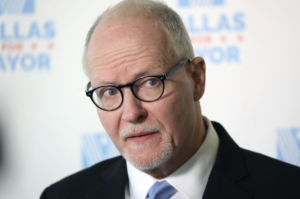 Chicago mayoral candidate Paul Vallas, a white middle-aged man with white hair and a white mustache and beard in black glasses